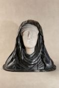 A Continental, probably Spanish alabaster and ebonised wood bust probably depicting the Virgin of So