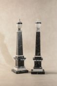 A pair of black fossil marble and white marble models of obelisks