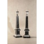 A pair of black fossil marble and white marble models of obelisks