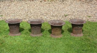 A set of four cast iron garden urns