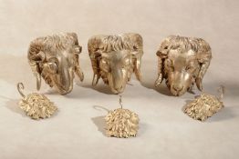 A set of three carved and gilt composition mounts modelled as rams' masks