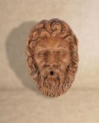 A substantial sculpted marmo Verona wall fount modelled as a bearded Bacchic mask in Baroque taste