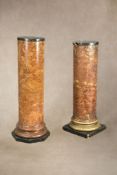 A near pair of painted plaster, marble topped and wood mounted pedestals,