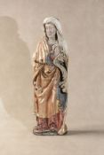A Continental carved, parcel gilt and polychrome painted softwood model of a female saint,