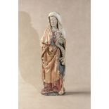 A Continental carved, parcel gilt and polychrome painted softwood model of a female saint,