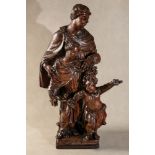 A Continental carved and stained walnut figural group,