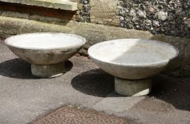 A pair of stone composition circular garden planters by Willy Guhl