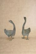 A pair of patinated copper alloy garden models of geese,