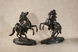 After Guillaume Coustou the Elder, (French 1677 - 1746), a pair of bronze models of the Marly Horses