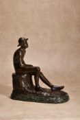 λ Karl May, (German, 1884 - 1961), a patinated bronze model of a seated boy wearing a hat,