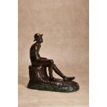 λ Karl May, (German, 1884 - 1961), a patinated bronze model of a seated boy wearing a hat,