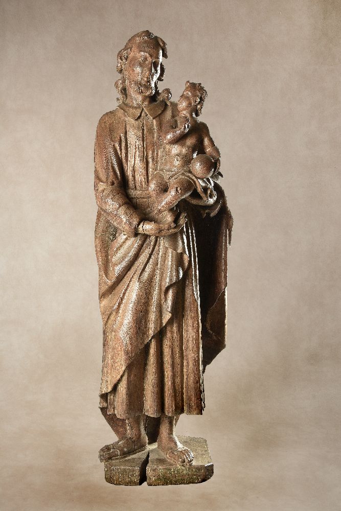 A sculpted oak group of Saint Joseph with the Infant Christ