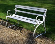 A painted wrought iron and slatted wood garden bench
