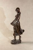 A Continental patinated bronze model of a Dutch maiden