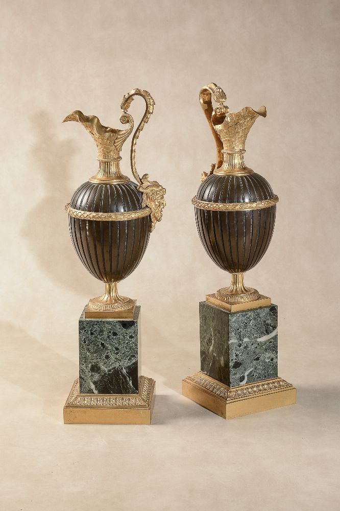 A pair of gilt and patinated bronze and Italian green serpentine marble mounted models of ewers