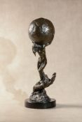 A French patinated bronze model of a maiden holding a globe