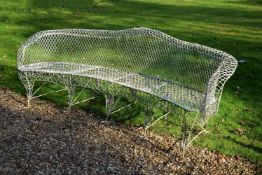 A painted wrought iron and wirework exedra bench