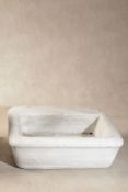 A rectangular white marble wall basin,