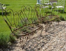 A pair of Victorian wrought iron garden seats