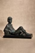 λ Karin Jonzen, (1914 - 1998), a patinated bronze model of a reclining youth,