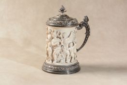 ϒ A German carved ivory and silver plated metal mounted tankard