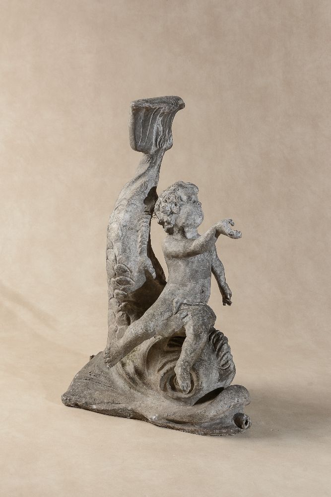 A lead fountain group of a putto riding a dolphin