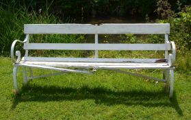 A painted wrought iron and slatted wood garden bench