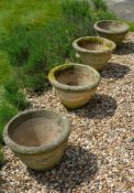 A set of four stone composition planters