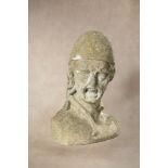 A sculpted limestone bust, possibly of a gorgon,