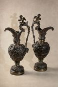 A pair of Continental patinated bronze models of ewers in the Renaissance Revival taste