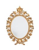 A pair of carved giltwood oval wall mirrors