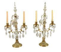 A pair of cut glass and rock crystal mounted gilt metal twin light candelabra in 18th century taste