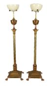 A pair of French gilt metal and copper mounted standard oil lamp bases in Neoclassical style