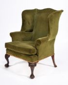 A George III mahogany and upholstered wing armchair
