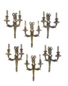 A set of five gilt bronze twin light wall appliques in Louis XVI taste by Henry Dasson