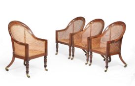 A set of four George IV mahogany bergere library armchairs