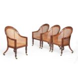 A set of four George IV mahogany bergere library armchairs