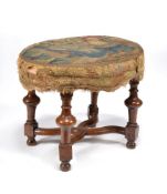 A William III walnut oval stool, circa 1700