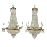 A pair of cut glass and gilt metal mounted four branch chandeliers in Regency taste