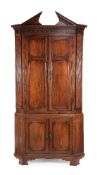 A George III mahogany standing corner cupboard