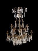 A Continental probably French, wrought and gilt metal and cut glass mounted nine light chandelier in