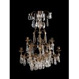 A Continental probably French, wrought and gilt metal and cut glass mounted nine light chandelier in
