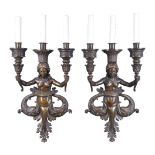 A pair of Continental patinated bronze three light figural wall appliques in Renaissance Revival tas