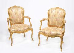 A pair of George III carved giltwood armchairs