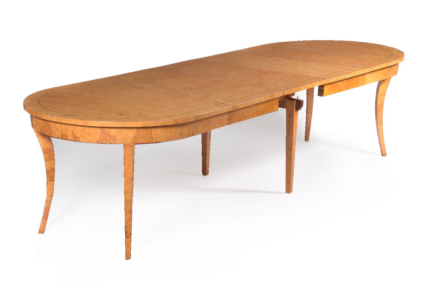 A Baltic karelian birch extending dining table