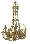 A gilt and painted metal twelve light chandelier in Louis XVI style