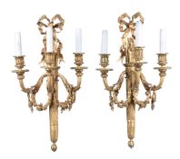 A set of six French gilt bronze three light wall appliques in Louis XVI style