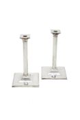 A pair of plain silver candlesticks by Theo Fennell