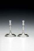 A pair of Queen Anne silver small taper sticks by Pierre Platel
