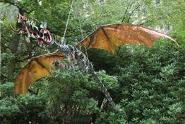 A copper and bronze model of a flying dragon